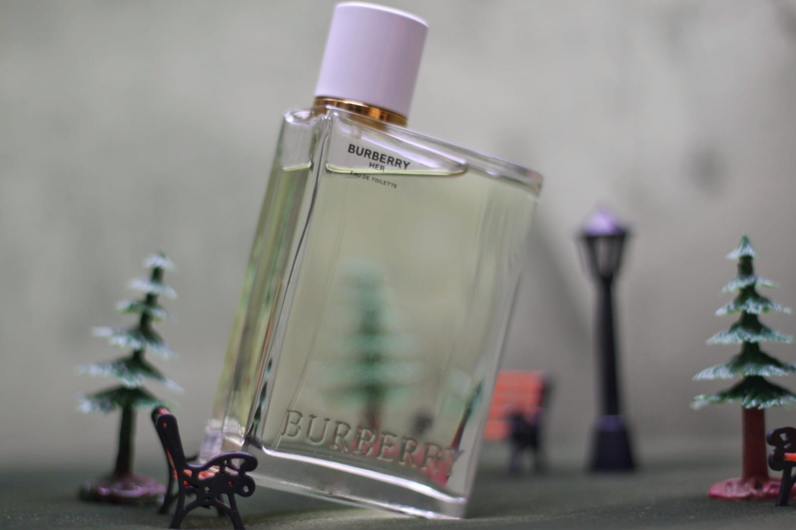 Tilted Burberry Her bottle with miniature trees lamps and benches