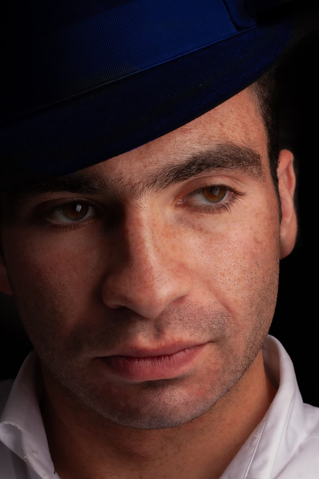 Close portrait of a person wearing a dark hat