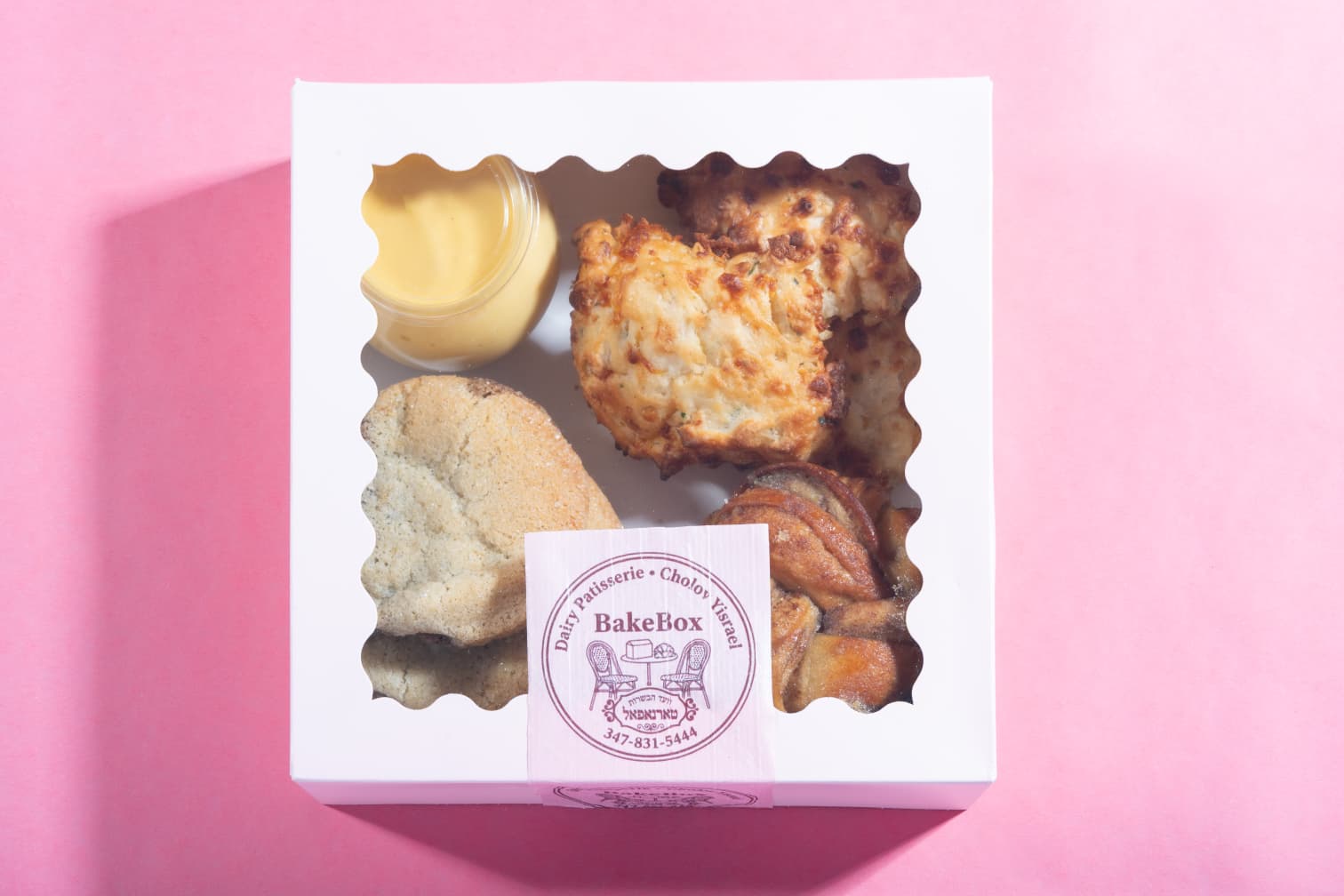 Box of pastries on a pink background