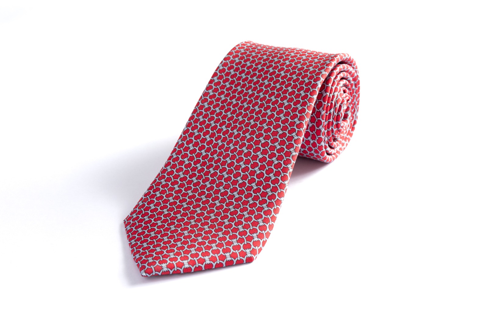 Rolled patterned red tie on white
