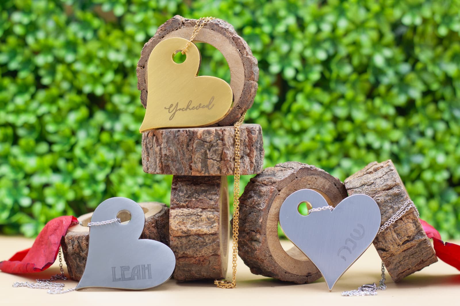Engraved heart pendants in gold and silver on stacked bark rounds